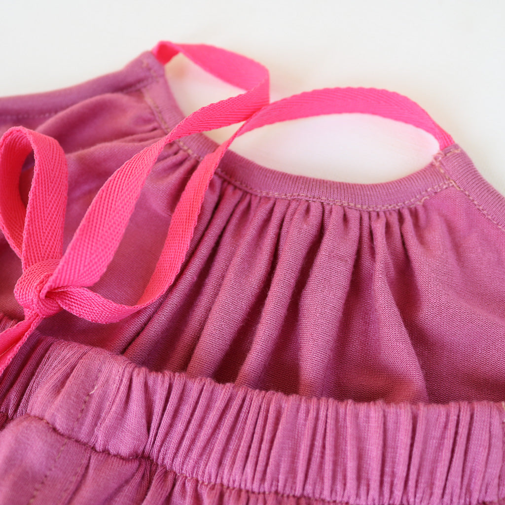 A purple Halter Neck romper by Hiccups & Buttercups