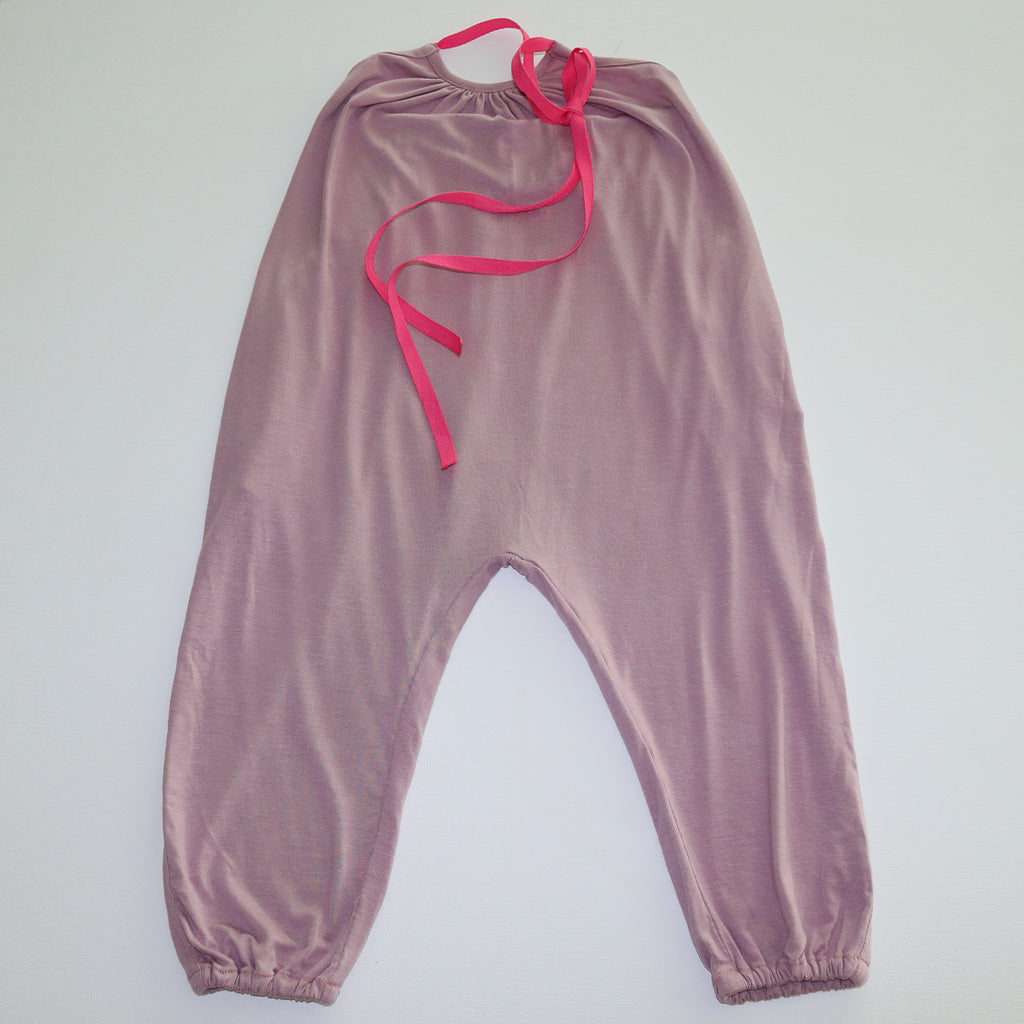 A pastel pink Halter Neck romper by Hiccups & Buttercups