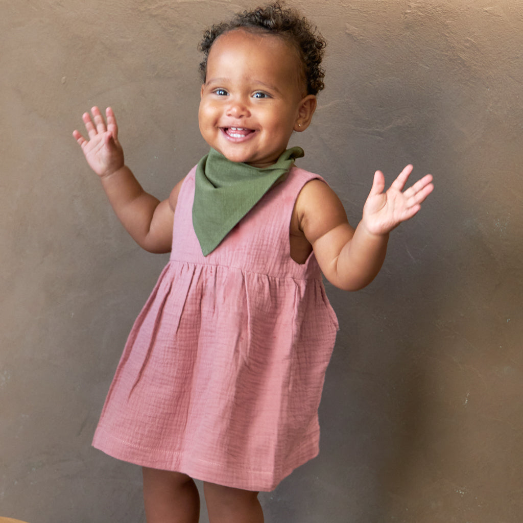 toddler wearing light pink classic linen Hiccups and Buttercups Romper