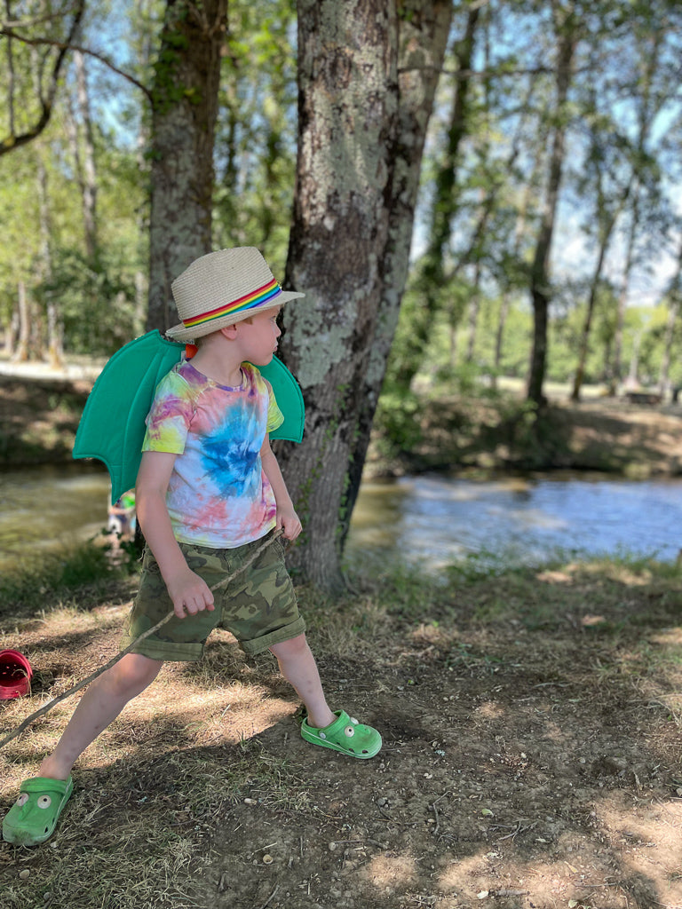 A boy wearing a dress up dragon wing by Hiccups & Buttercups