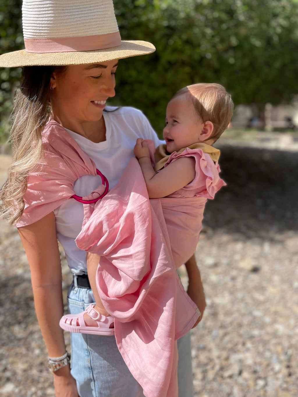 A mother holding her baby in a Hiccups & Buttercups baby sling