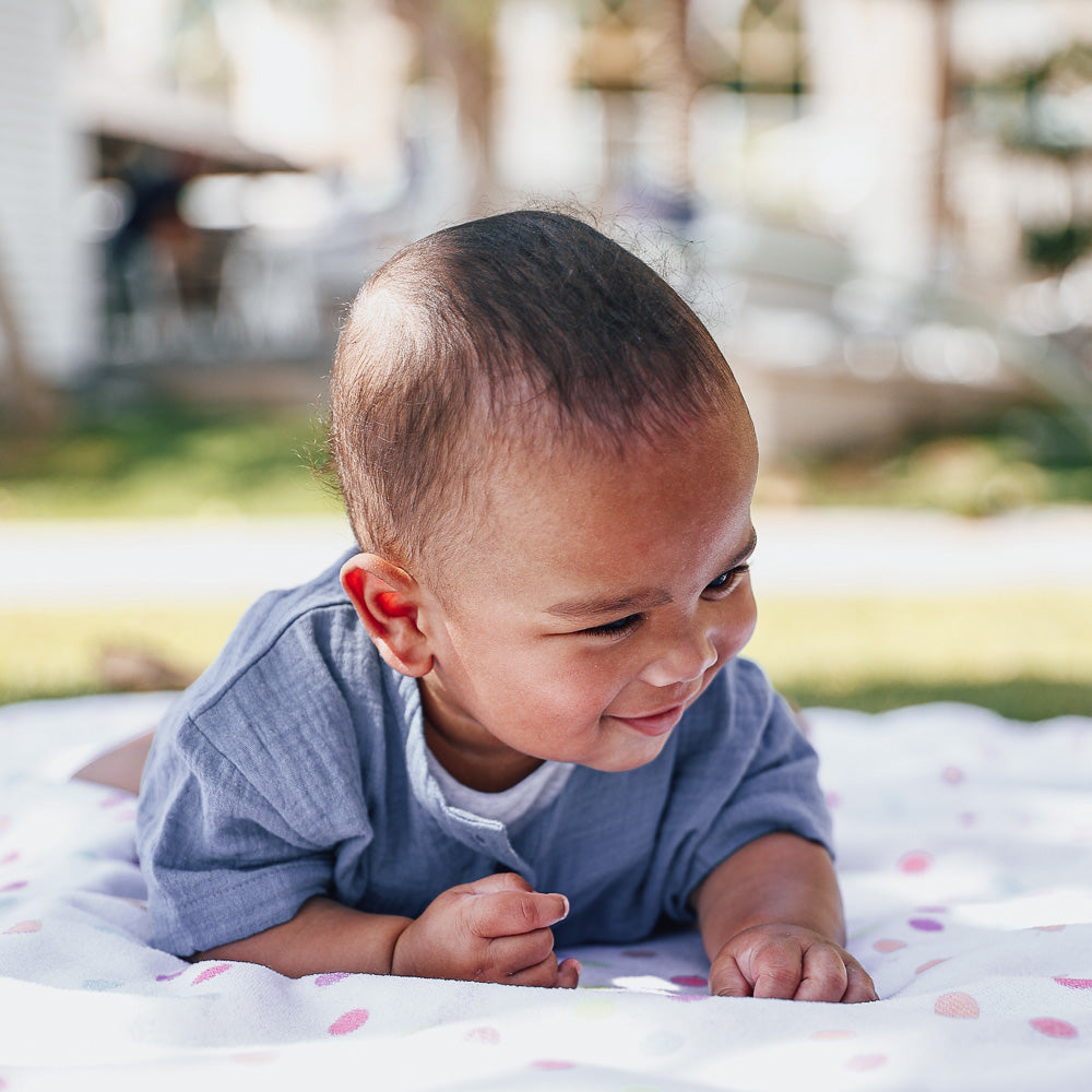 A blue organic cotton baby boys onesie by Hiccups & Buttercups