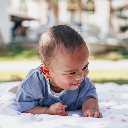 A blue short-sleeve cotton baby romper by Hiccups & Buttercups