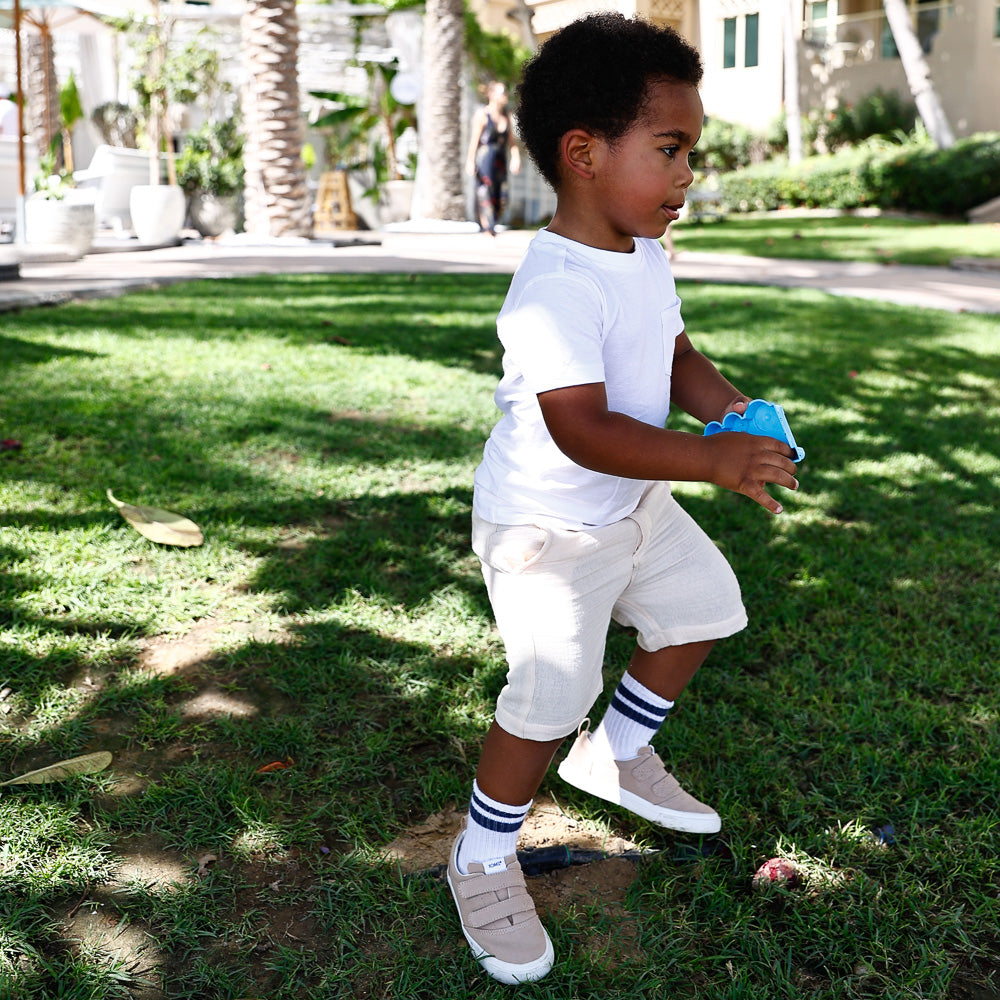 boy wearing cream colour shorts made from organic cotton by Hiccups & Buttercups 