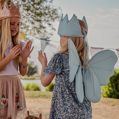 girls playing with dress up fairy wings and crowns