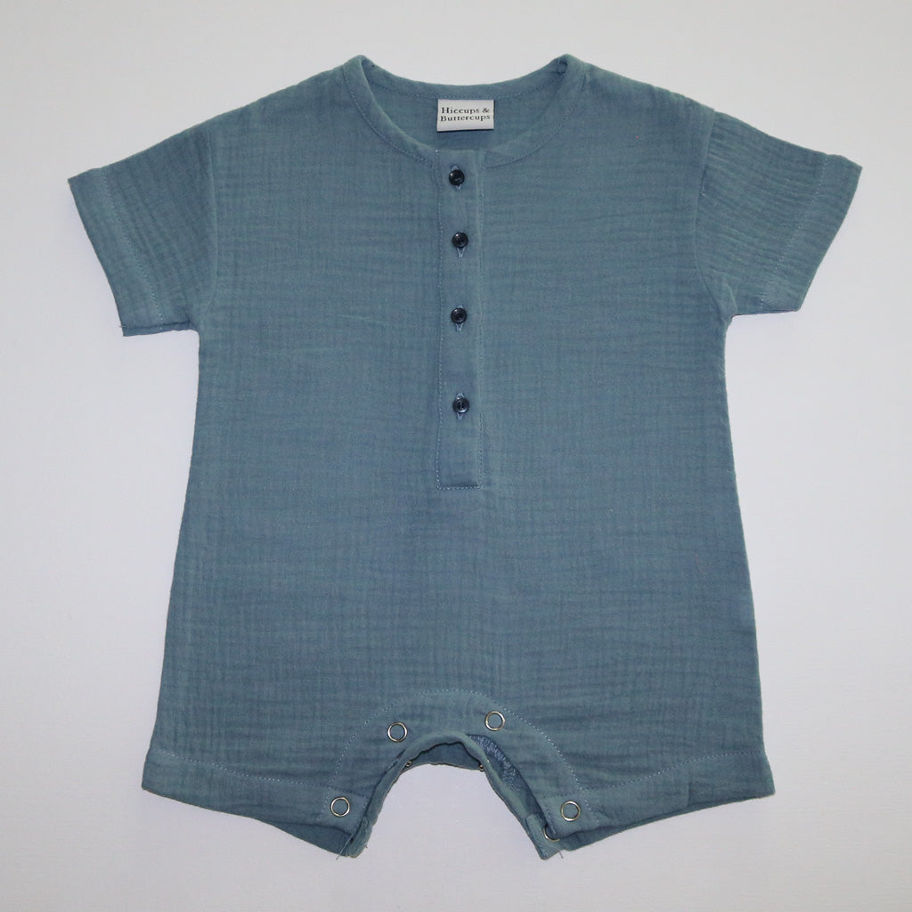 A blue organic cotton baby boys onesie by Hiccups & Buttercups