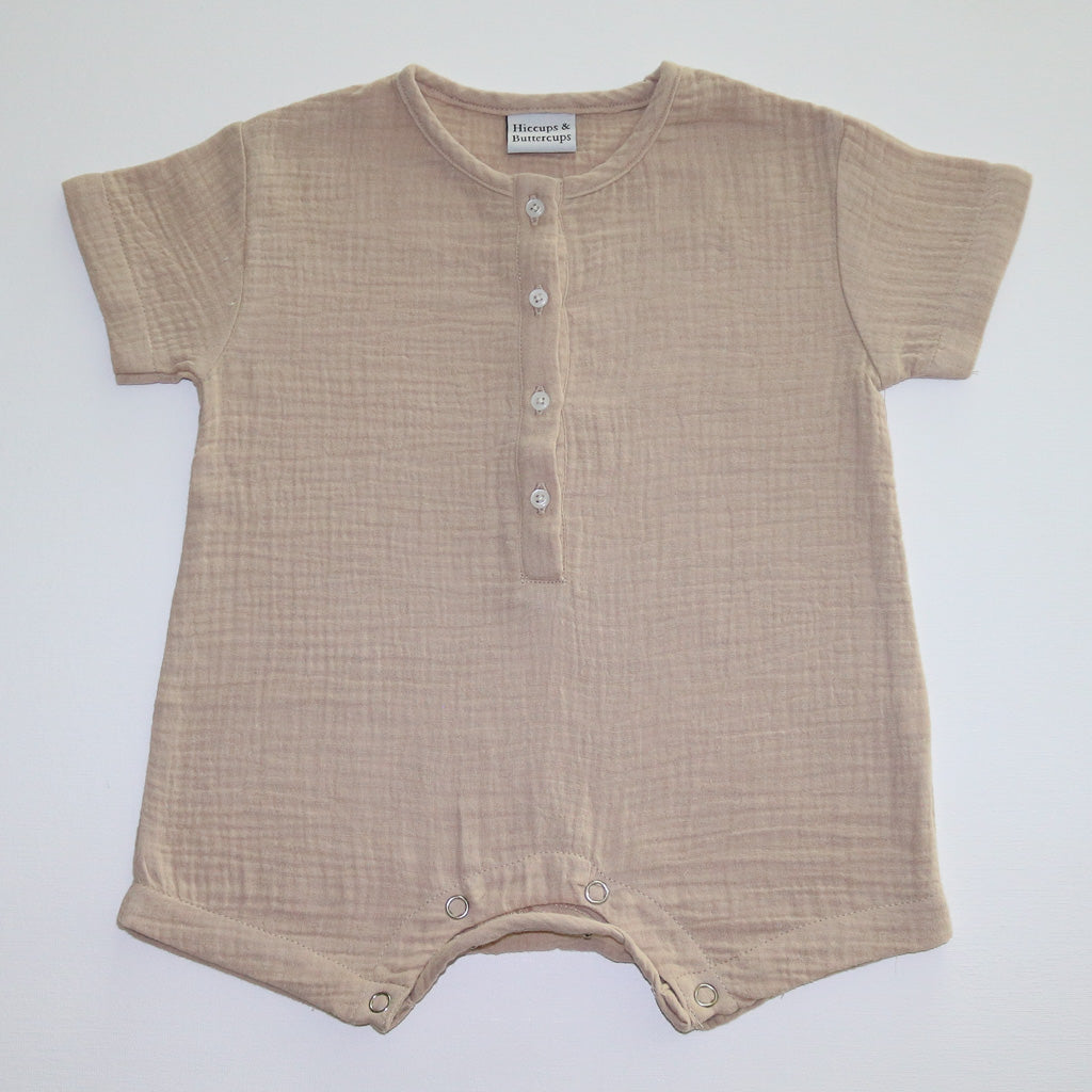 A beige organic cotton baby boys onesie by Hiccups & Buttercups